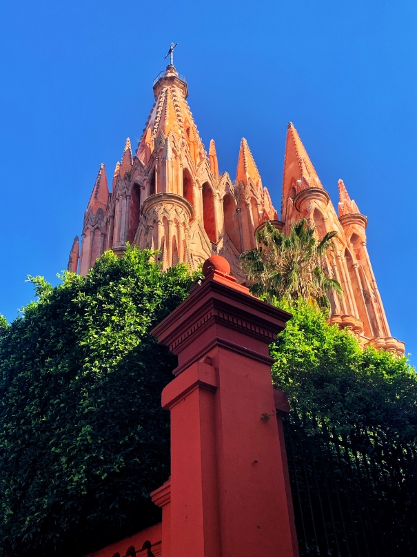 Parish church of San Miguel de Allende behind shrubbery