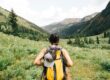 Woman hiking through green hills