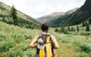 Woman hiking through green hills