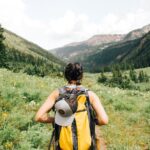 Woman hiking through green hills