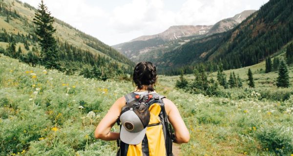 Woman hiking through green hills