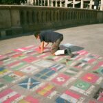 man drawing on floor