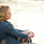 Profile of Charlotte Tweed sitting beside a river