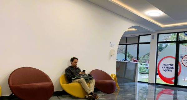 man sitting in a clinic waiting room