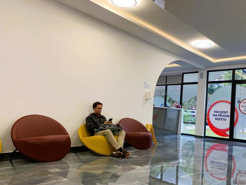 man sitting in a clinic waiting room