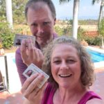 Permanent residency in Mexico. Two people holding their residency cards.